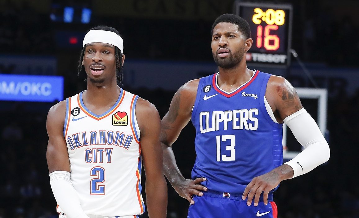 Oct 27, 2022; Oklahoma City, Oklahoma, USA; Oklahoma City Thunder guard Shai Gilgeous-Alexander (2) and LA Clippers guard Paul George (13) walks down the court during a time out during the first half at Paycom Center.