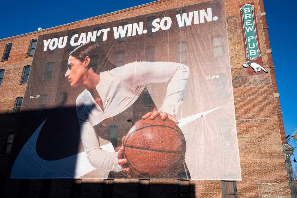 Nike banners featuring Caitlin Clark are installed along the eastern side of Des Moines' Court Avenue Restaurant and Brewing Company on Thursday, Feb. 20, 2025.